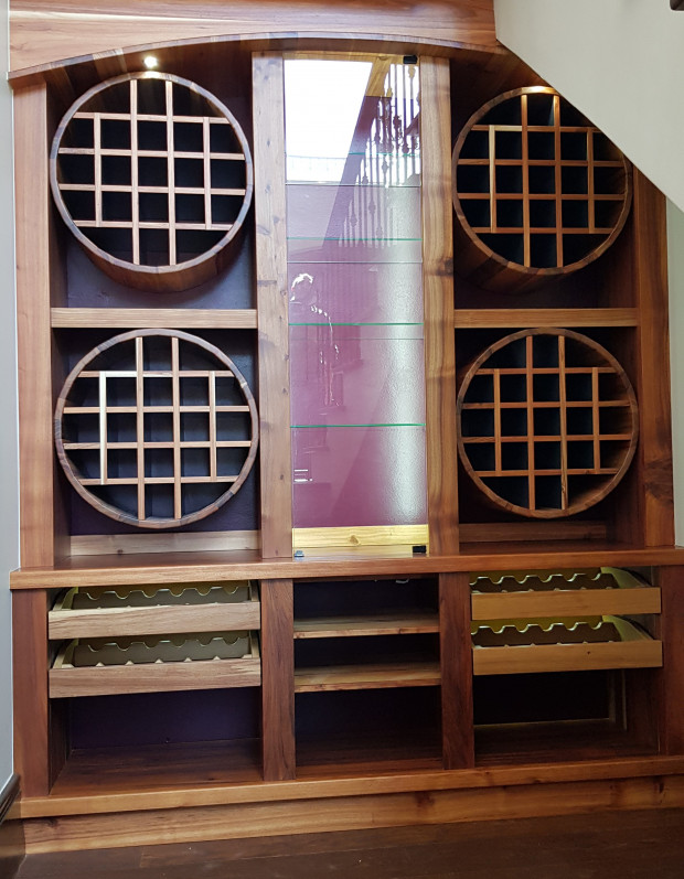 Wine cellar in Solid Black wood and Yellow wood with glass door in front of Glasses display area.d